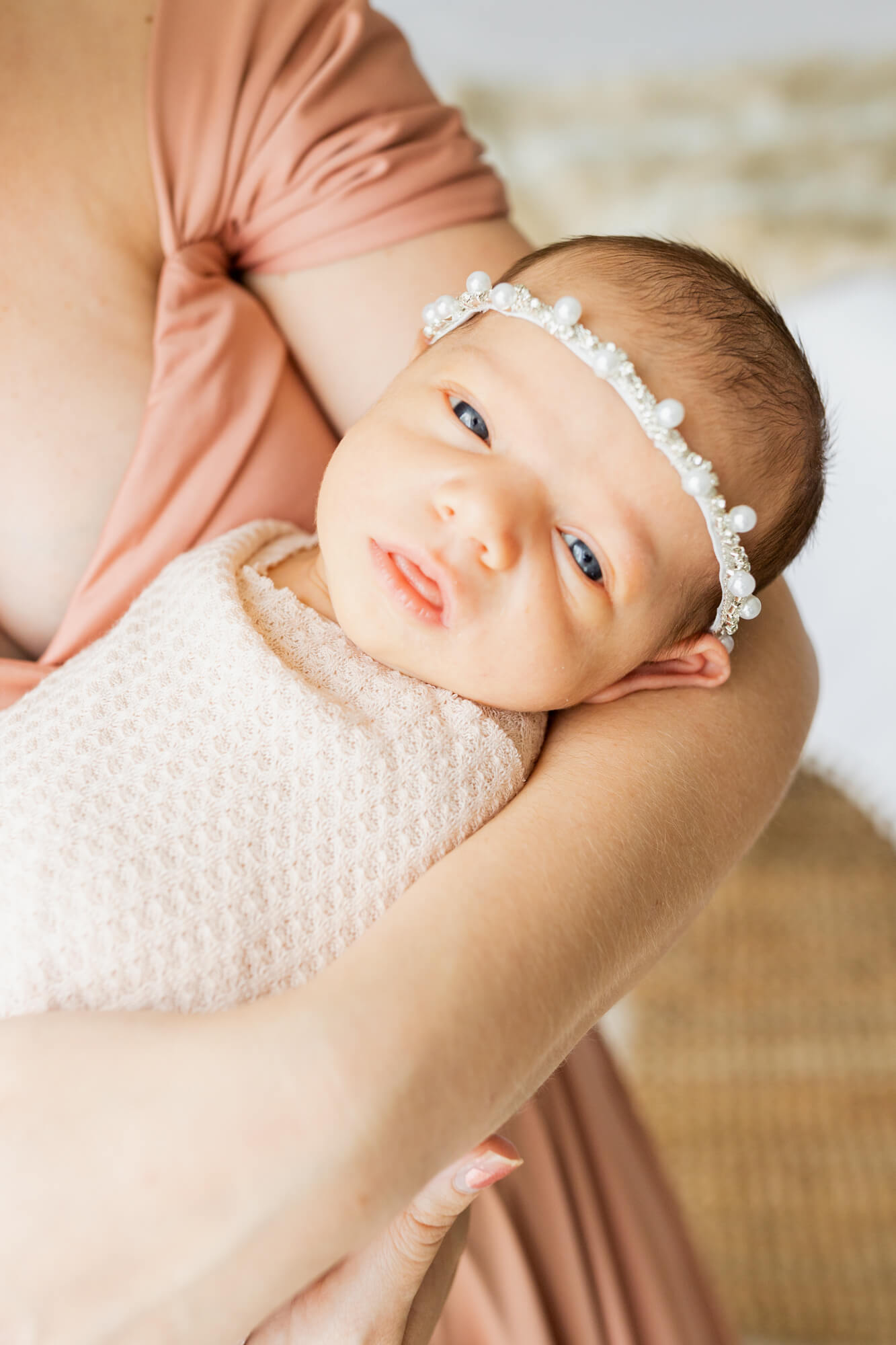 newborn baby girl in pearl headband with tongue out birthing classes birmingham al