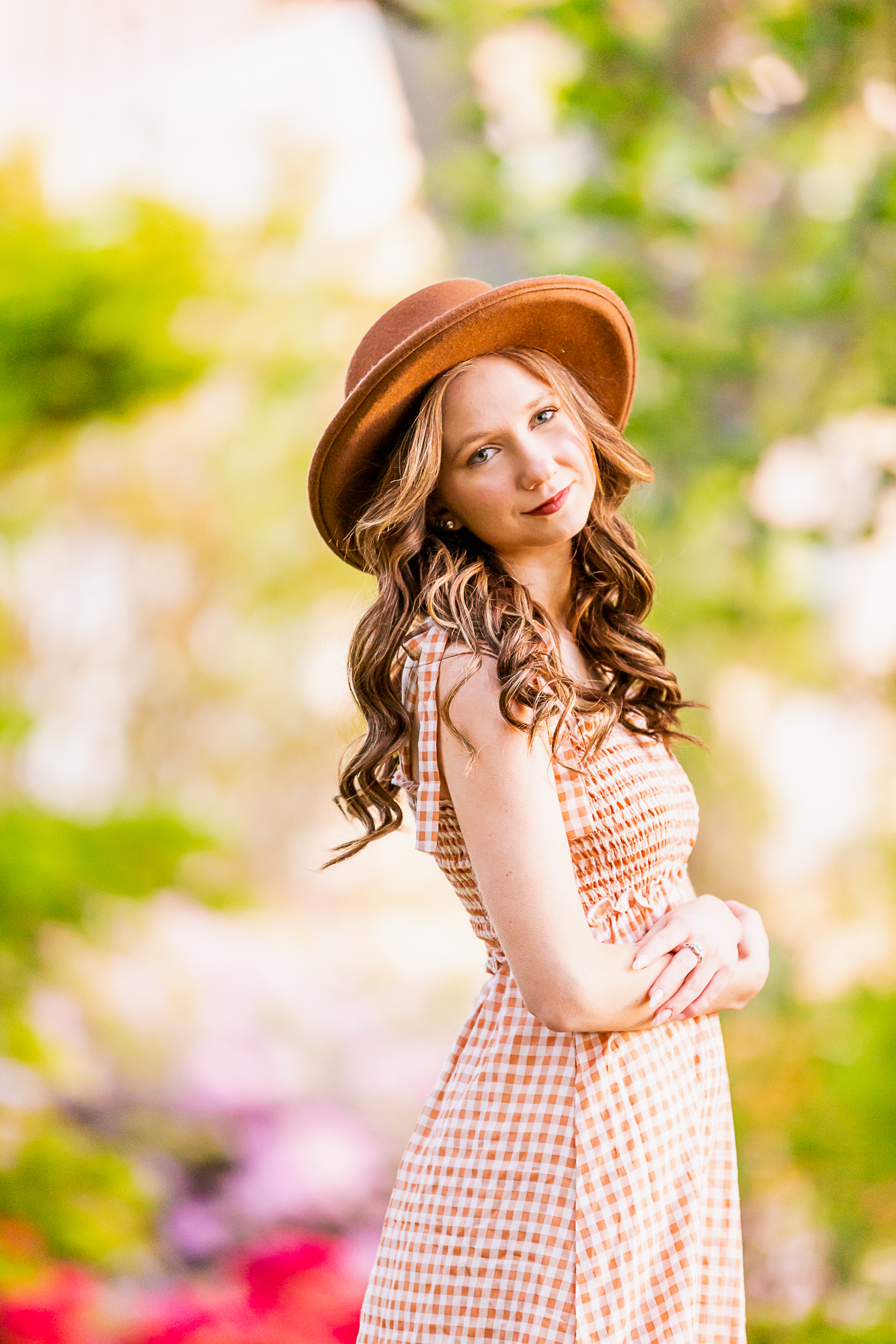 teen girl in gingham dress and brown hat with her arms crossed clothing stores birmingham al
