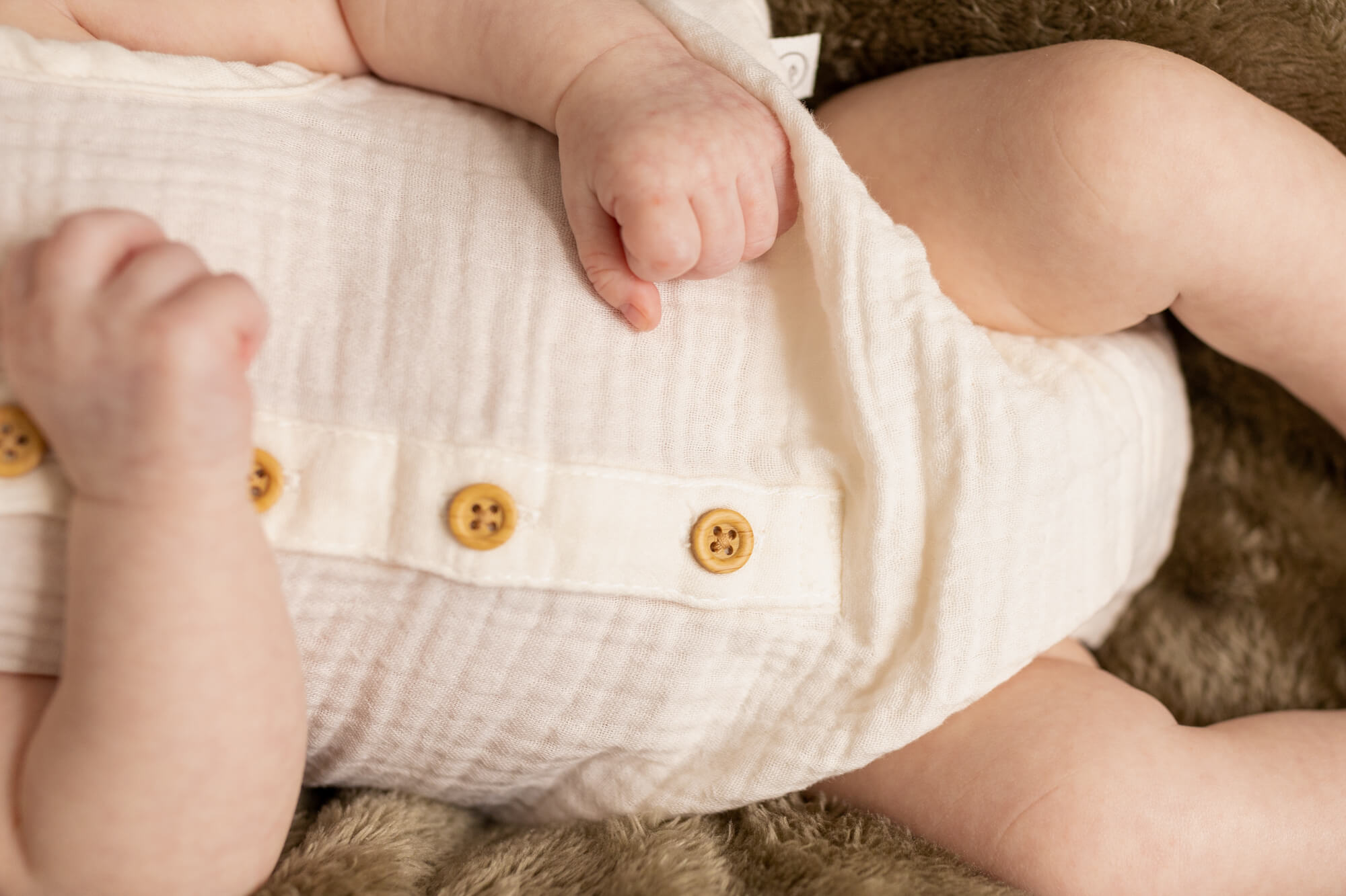 details of a newborn baby's onesie
