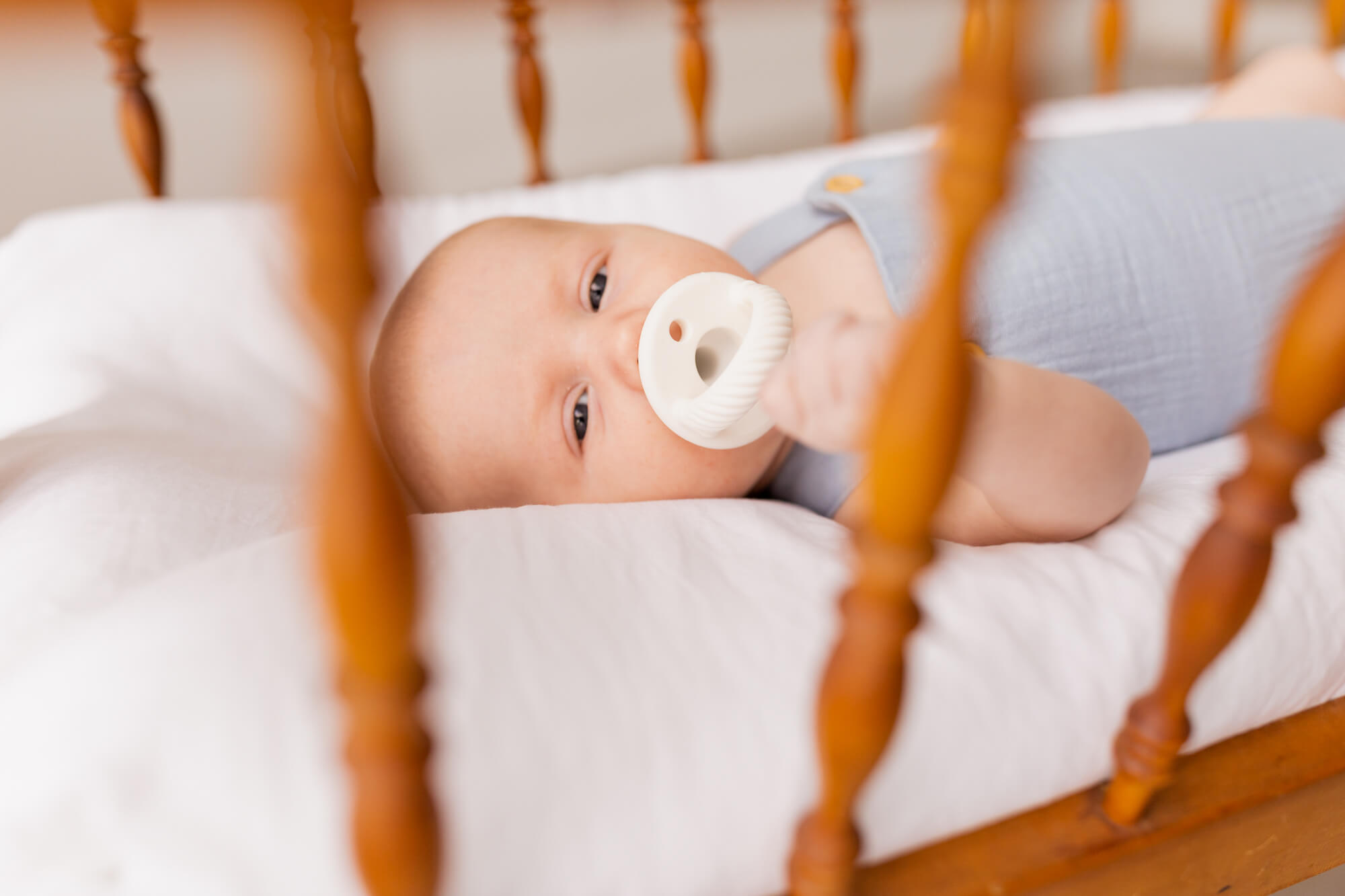 newborn baby in his crib with a pacifier Night Nurse Birmingham AL