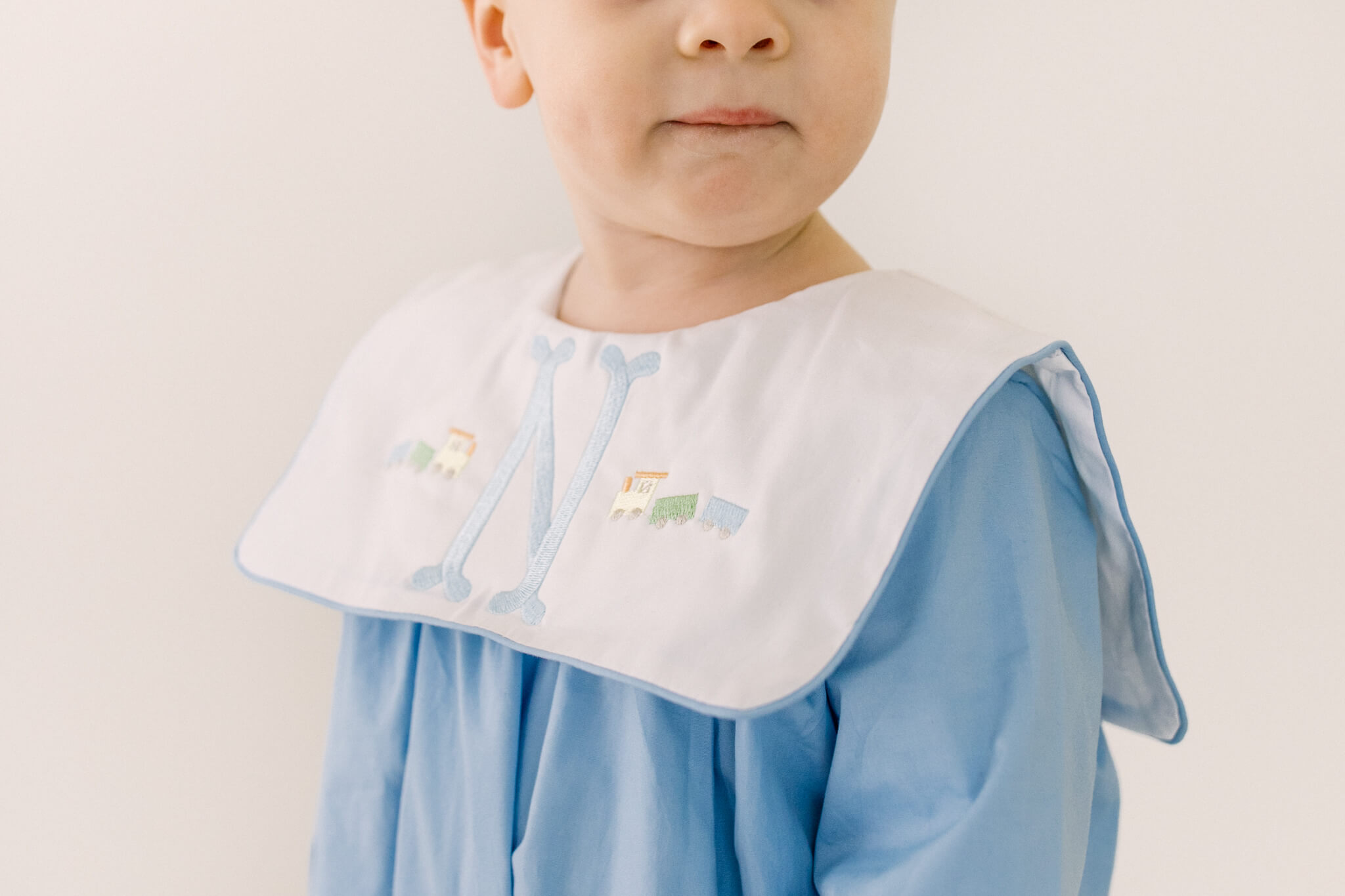 Details of a toddler's custom monogrammed bib